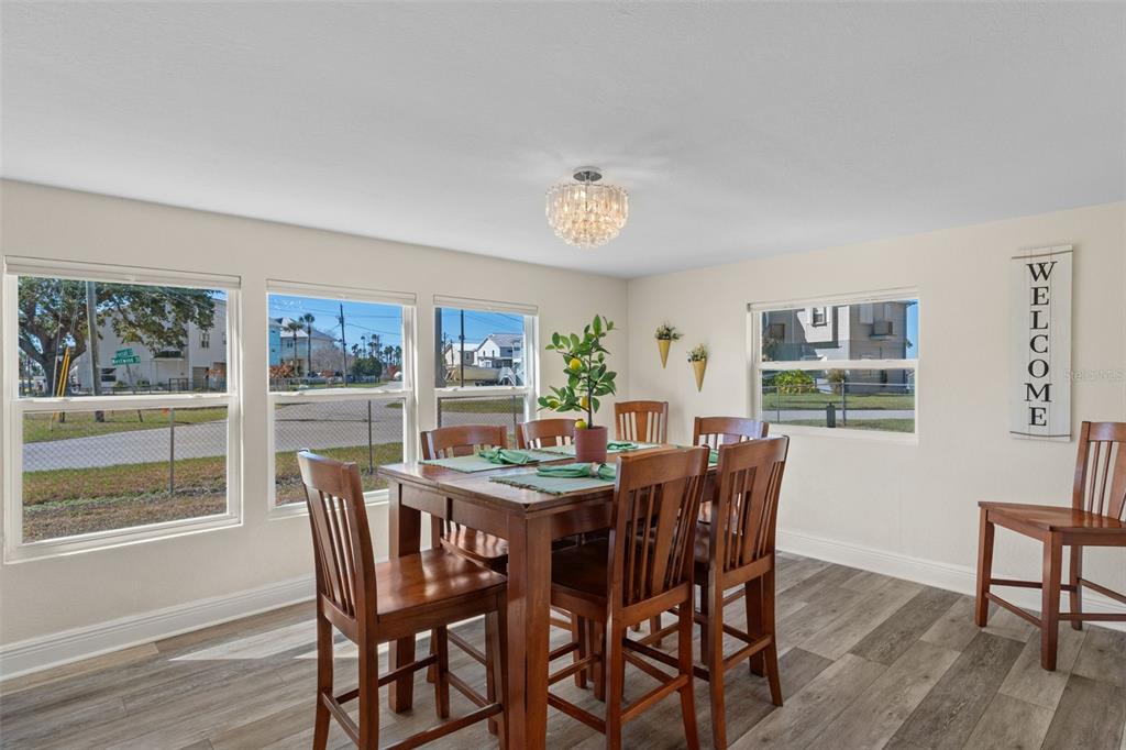 7272 Westwind Street Weeki Wachee, FL 34607 - Photo 19 of 33 a view of a dining room with furniture window and wooden floor