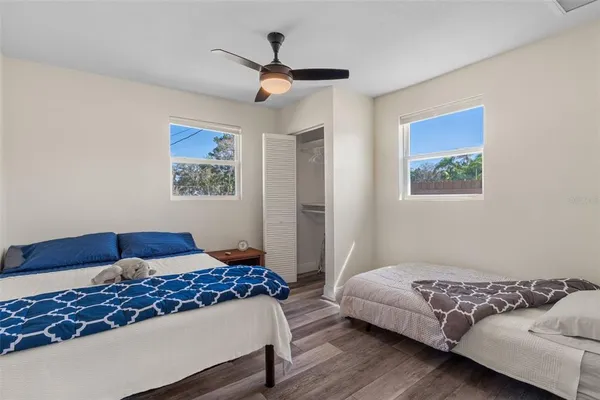 a bedroom with a bed and a painting on the wall