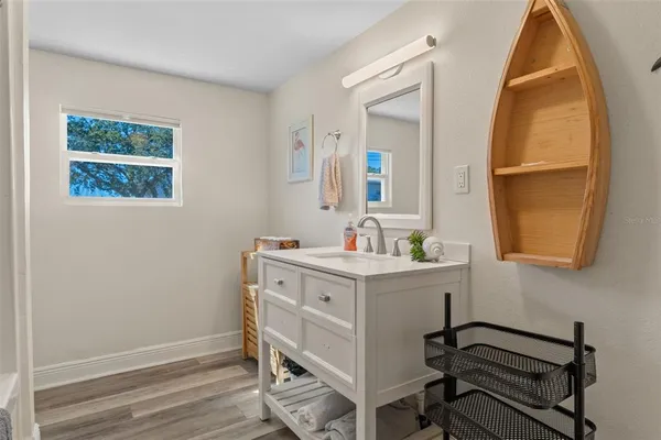 a view of a workspace room with a window and wooden floor