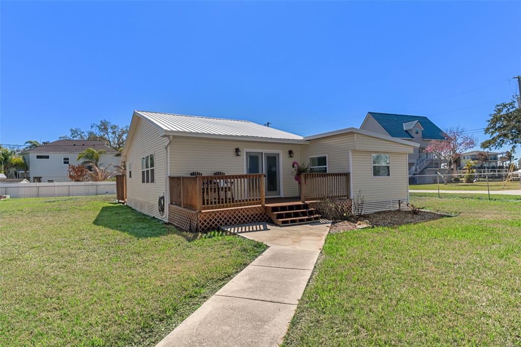 7272 Westwind Street Weeki Wachee, FL 34607 - Photo 31 of 33 a view of a house with a yard and sitting area