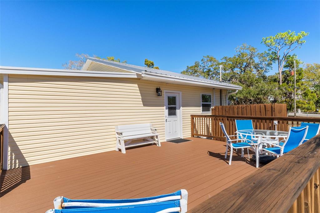 7272 Westwind Street Weeki Wachee, FL 34607 - Photo 5 of 33 a view of a house with wooden deck and furniture
