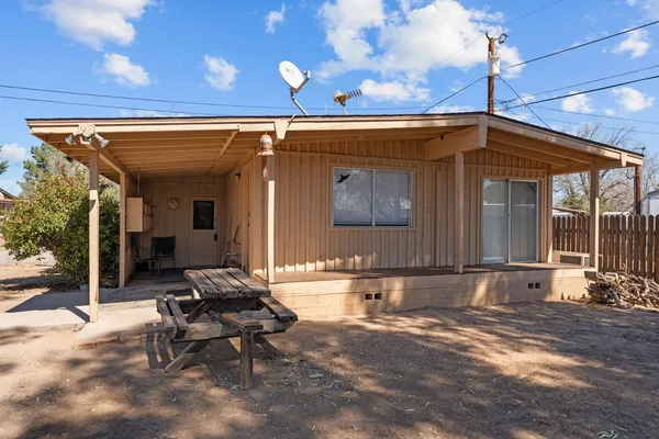 a backyard of a house with table and chairs