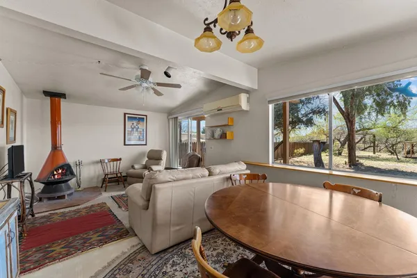 a living room with furniture gym equipment and a large window