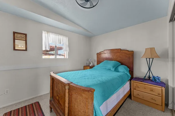 a bed sitting in a bedroom next to a window
