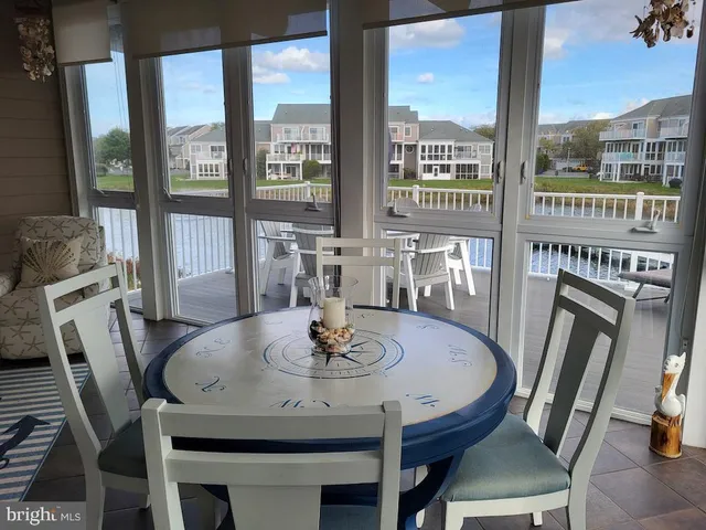 a kitchen with stainless steel appliances granite countertop a refrigerator a sink and white cabinets
