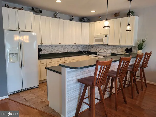 a view of a deck with a chair and floor to ceiling window