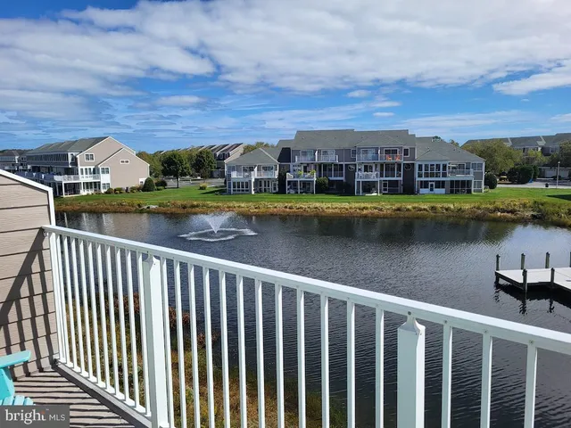 an aerial view of a city with lots of residential buildings and mountain view in back