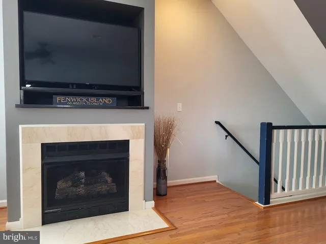 a living room with furniture a rug and a floor to ceiling window