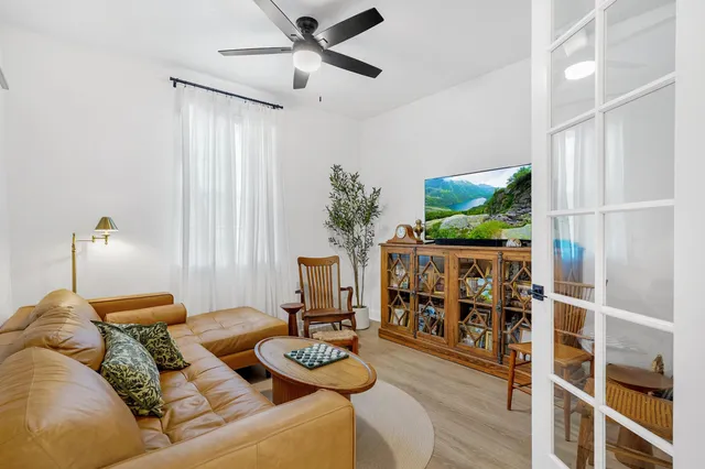 a living room with furniture and wooden floor