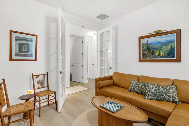 a living room with furniture and a blue wall