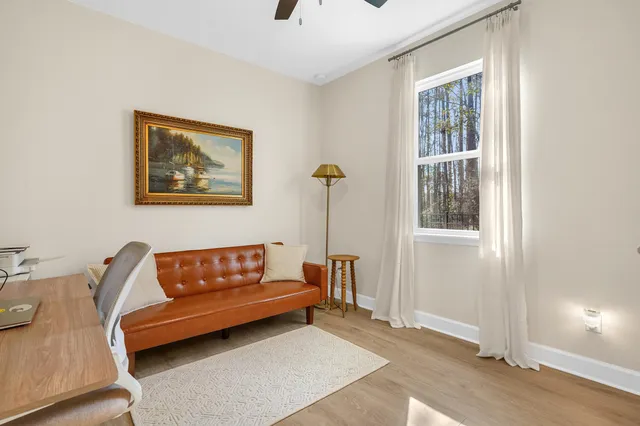 a couch sitting in a living room next to a window