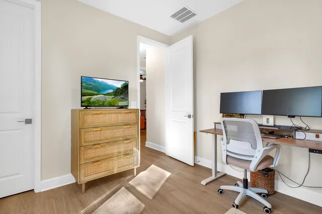 a workspace with furniture and a flat screen tv
