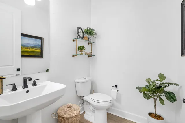 a white toilet sitting next to a bathroom sink