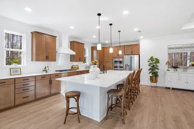 a large kitchen with a table and chairs