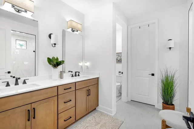a bathroom with a double vanity sink and a mirror