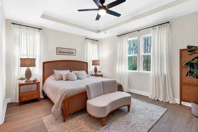 a bedroom with a bed couch and window