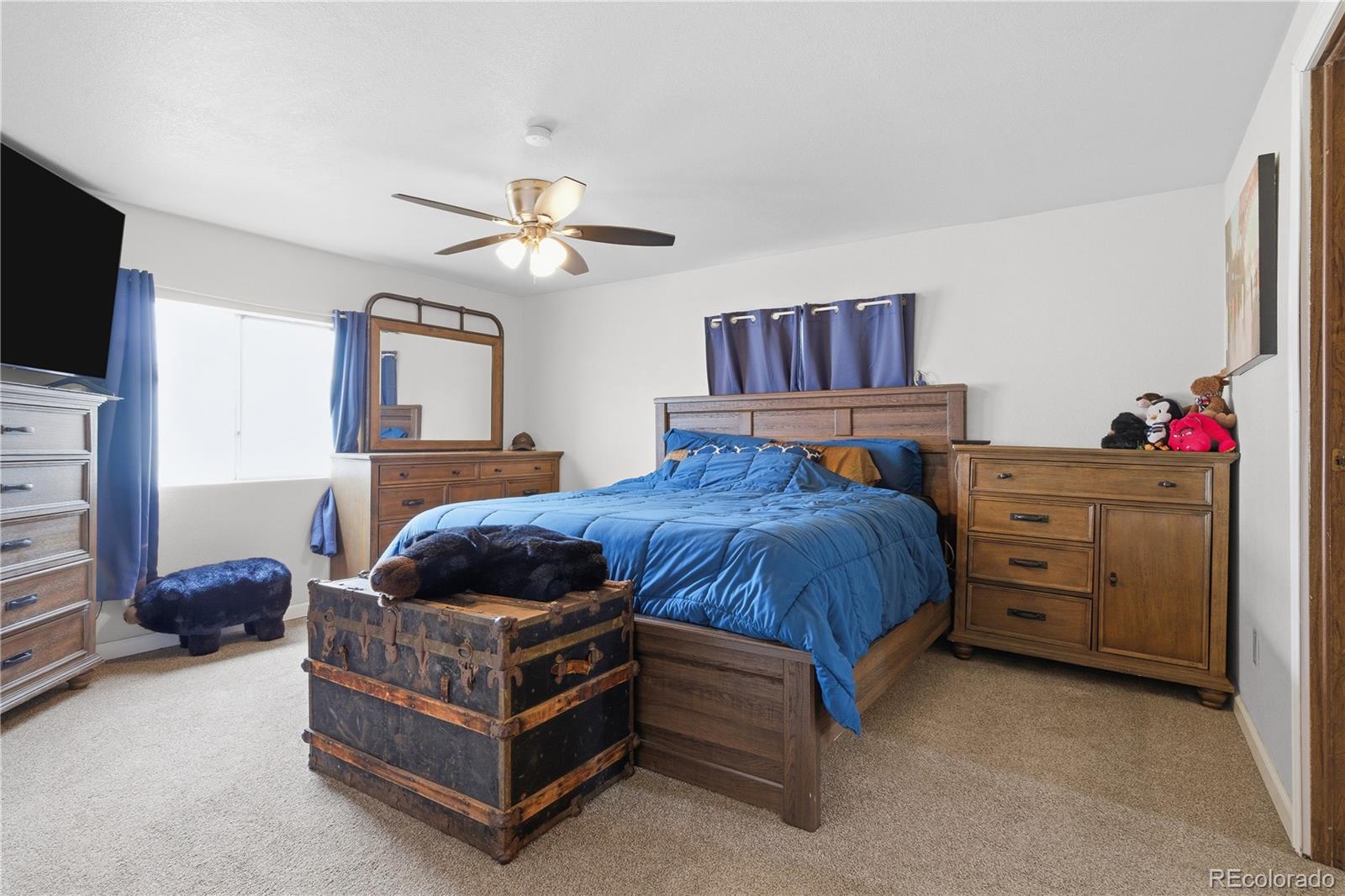 12205 Perry Street Broomfield, CO 80020 - Photo 15 of 22 a bed room with a bed and a television
