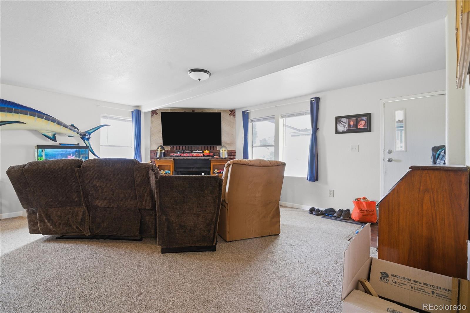 12205 Perry Street Broomfield, CO 80020 - Photo 2 of 22 a living room with furniture and a flat screen tv