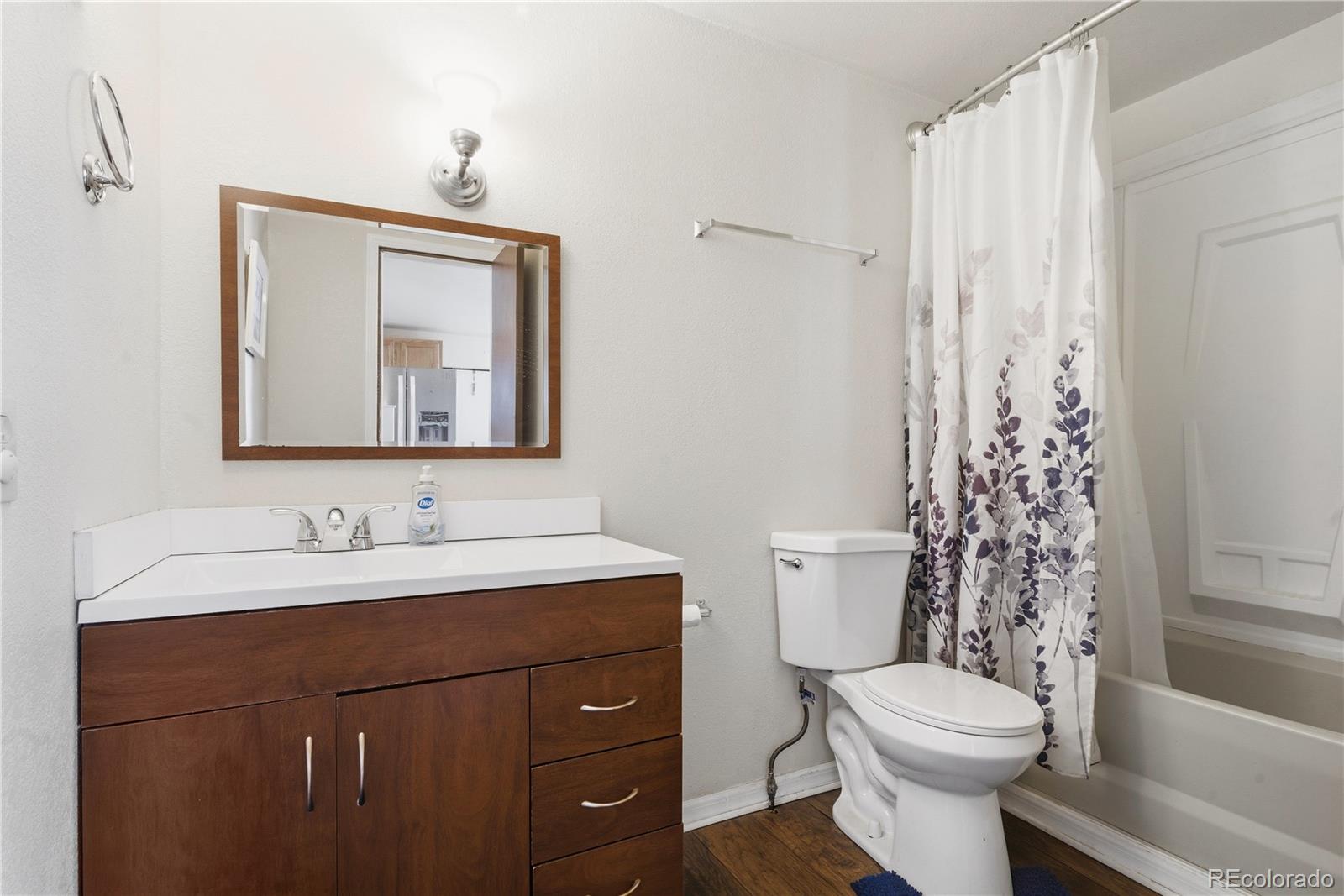 12205 Perry Street Broomfield, CO 80020 - Photo 8 of 22 a bathroom with a toilet sink and mirror