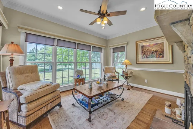 a living room with furniture a rug and a chandelier