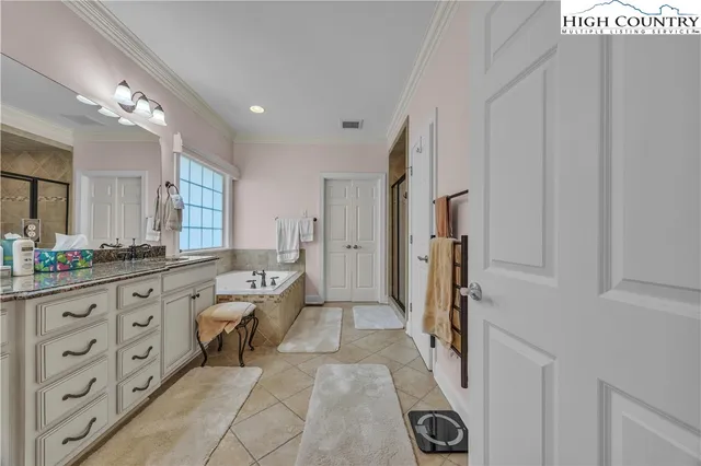 a bathroom with a granite countertop sink a toilet a mirror and shower