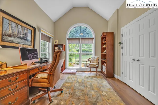 a view of a workspace with furniture and a window