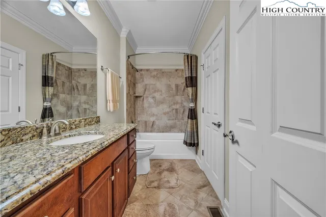 a bathroom with a granite countertop sink a mirror and a shower