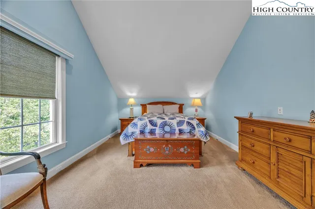 a bed room with a bed and a window