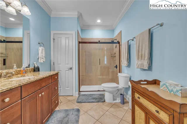 a bathroom with a double vanity sink toilet and shower