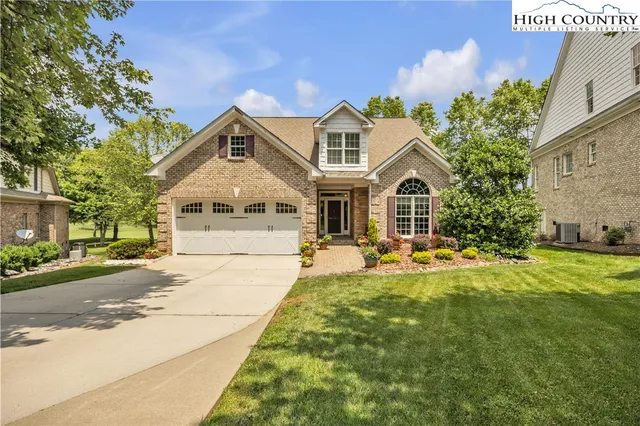 a front view of a house with swimming pool and porch with furniture