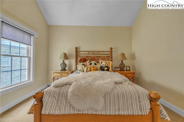 a bed sitting in a bedroom next to a window