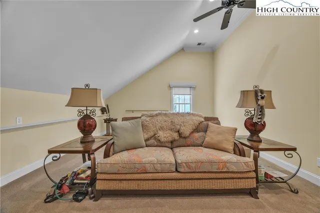 a living room with furniture and a gym machine