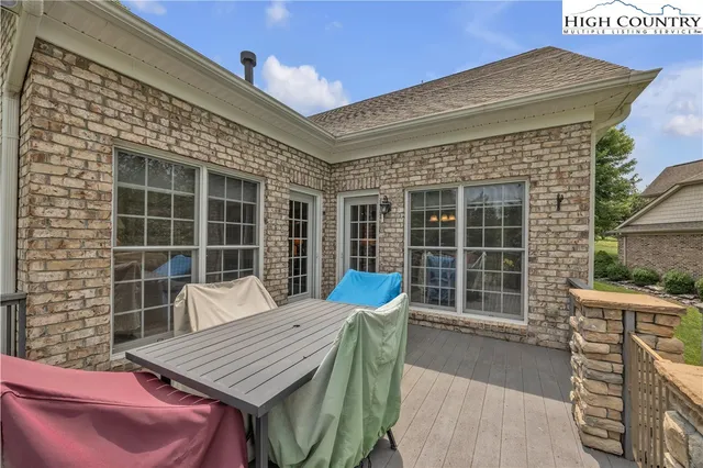 a view of a patio with table and chairs
