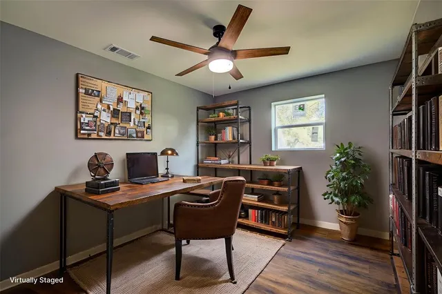 a work room with furniture and a bookshelf