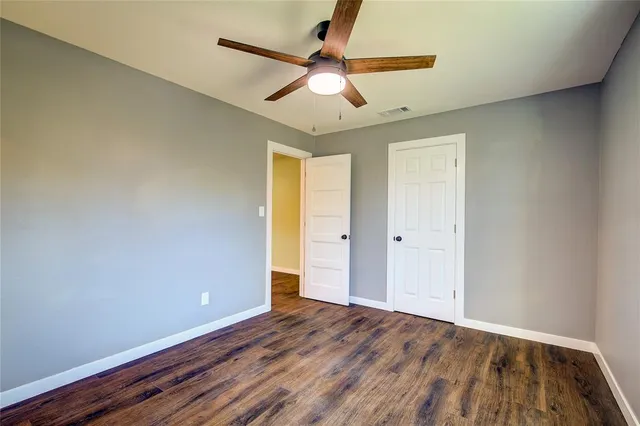 a view of room with window and wooden floor
