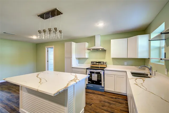 a kitchen that has a sink and a stove in it