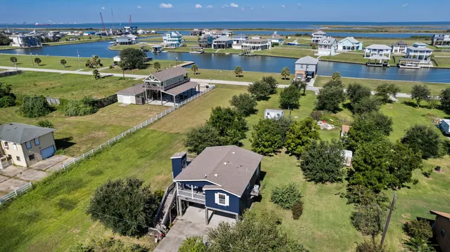 an aerial view of a house with a lake view