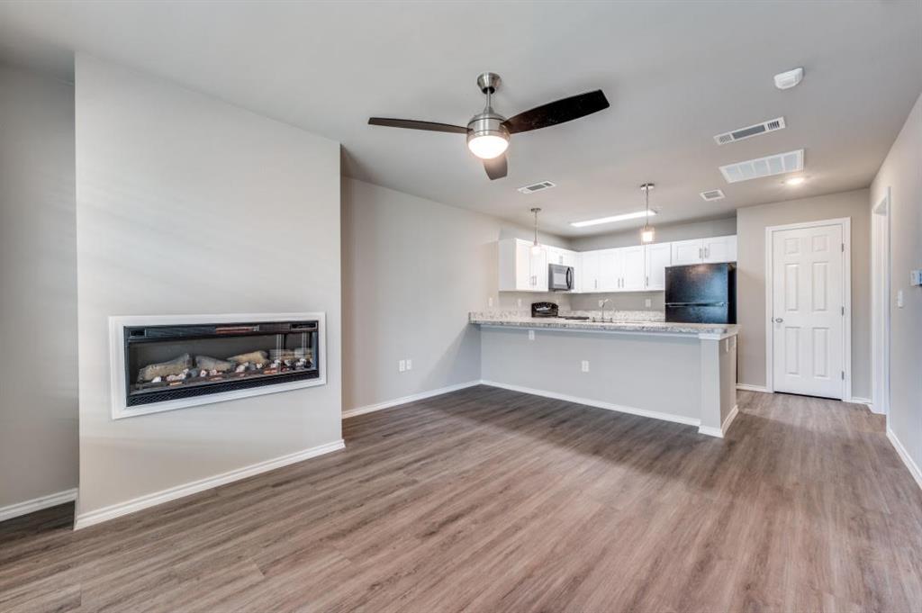 6108 Abrams Road, Unit 218 Dallas, TX 75231 - Photo 1 of 11 a view of kitchen with cabinets and wooden floor