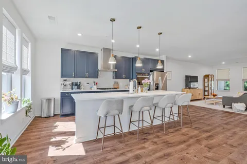 a kitchen with stainless steel appliances kitchen island granite countertop a sink and cabinets