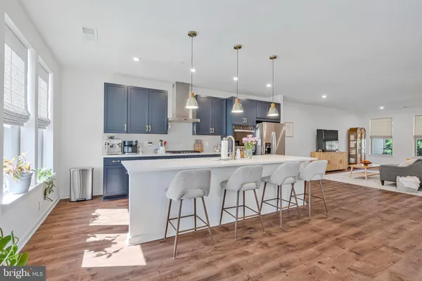 a kitchen with stainless steel appliances kitchen island granite countertop a sink and cabinets