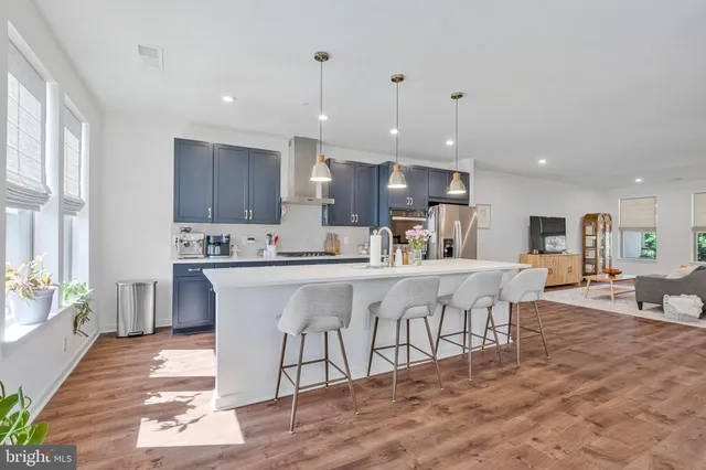 a kitchen with stainless steel appliances kitchen island granite countertop a sink and cabinets