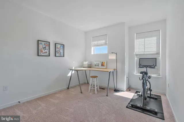 a bedroom with a bed and a ceiling fan