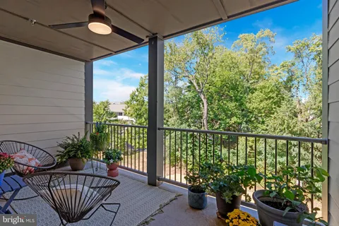 a balcony with furniture and a potted plant