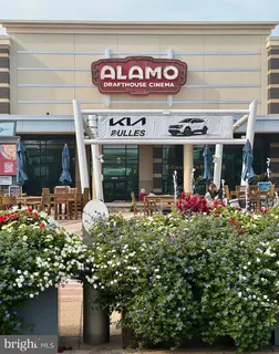 a front view of a multi story building with retail shops