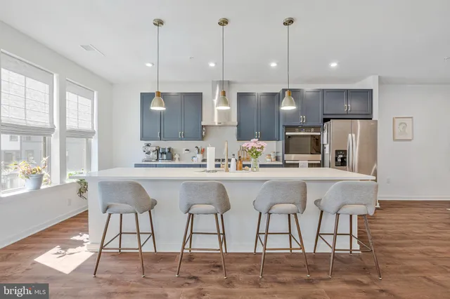 a white kitchen with a table and chairs