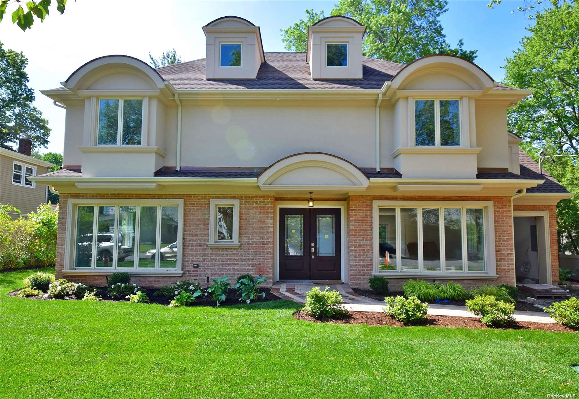 a front view of a house with a garden