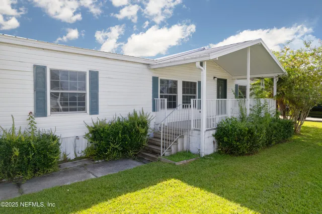 a view of an house with backyard space and garden