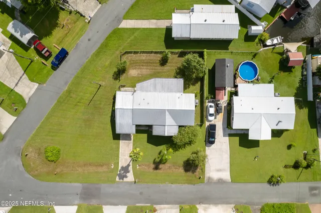 an aerial view of a house with a swimming pool