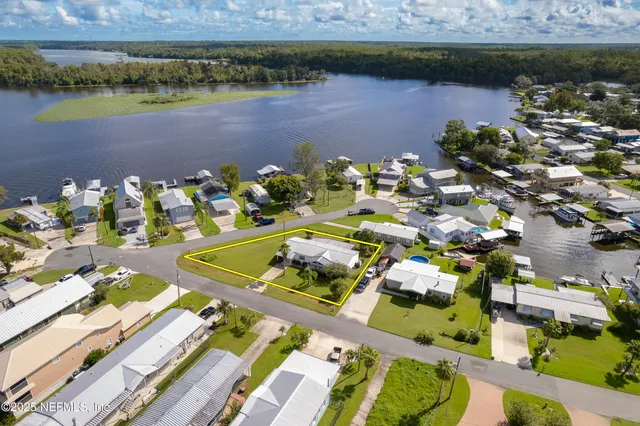 a view of a lake with a table and chairs