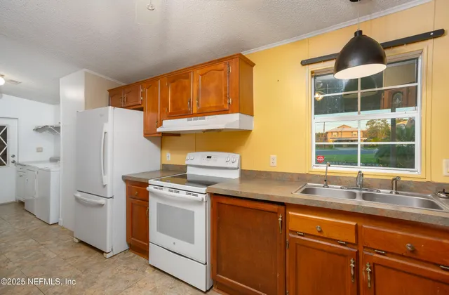 a kitchen with a sink and a refrigerator